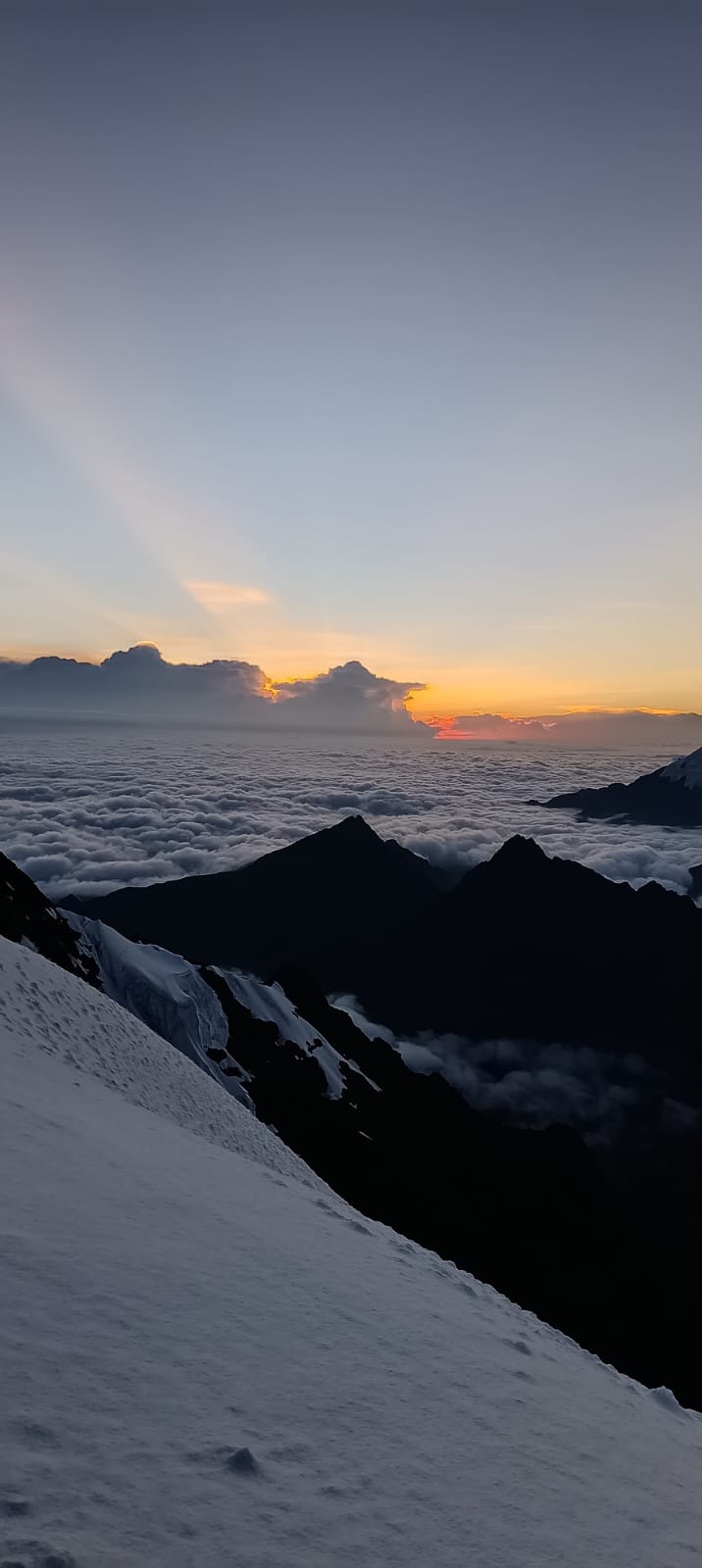 Sunrise over the sea of clouds from the glacier slope