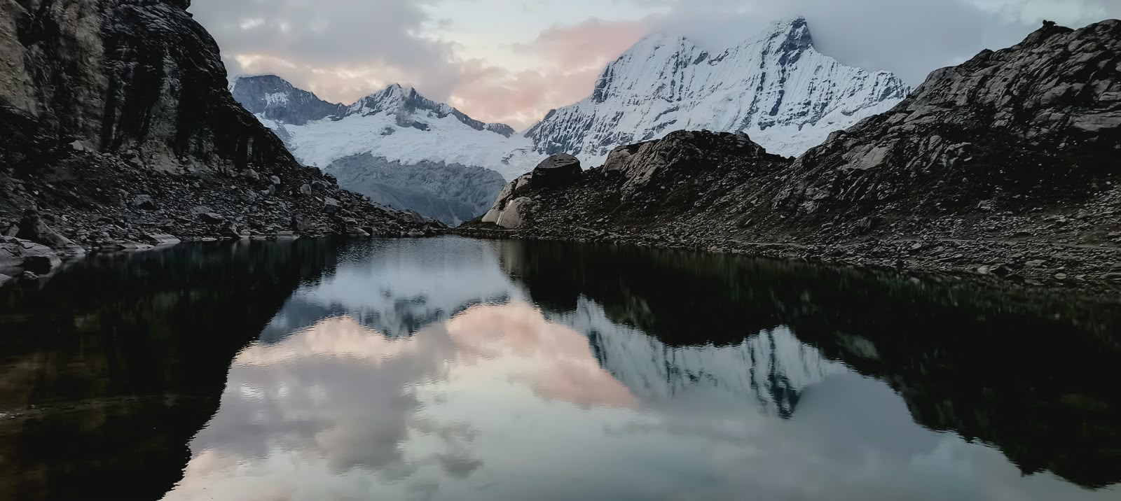 Snow peaks reflected in the Moraine Camp lake